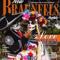 New Braunfels Monthly magazine cover featuring a Catrina couple from the Dia de los Muertos festival with the headline "Love Never Dies"